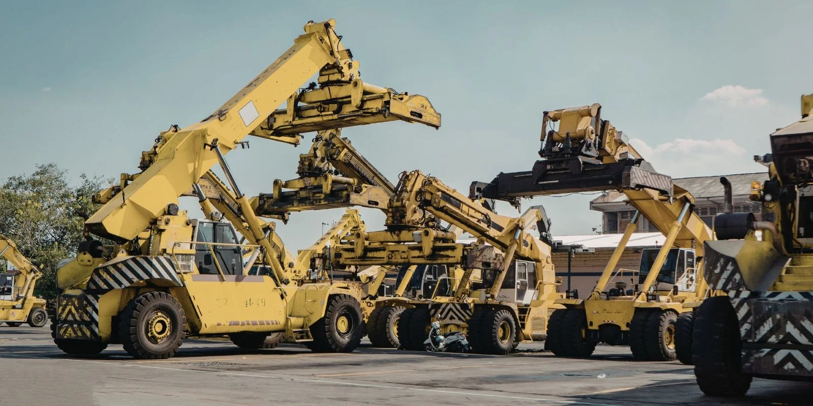 Heavy construction machinery prepared for shipping from Dubai to Africa